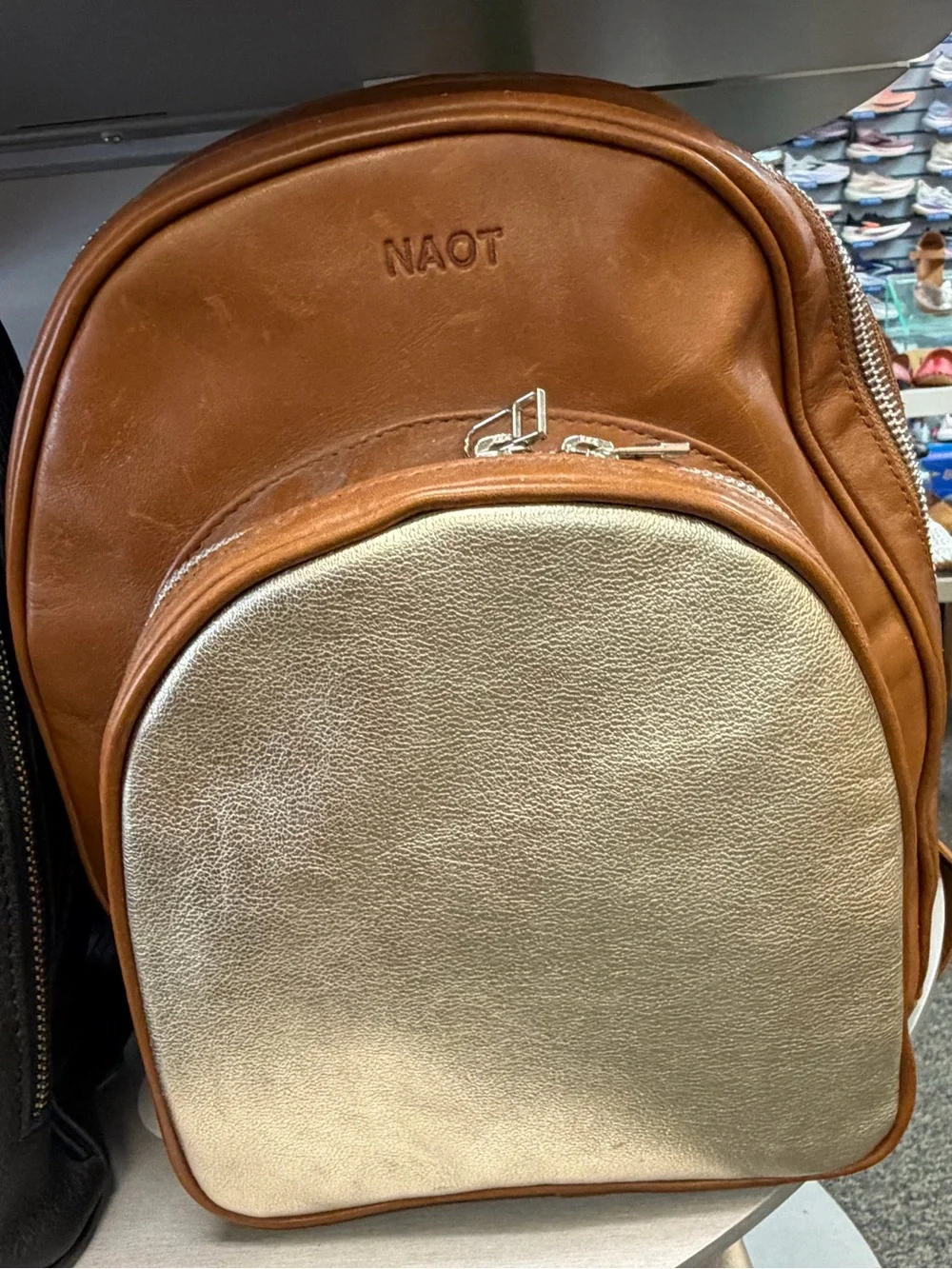 NAOT women’s Tan and Metallic Gold Leather Backpack